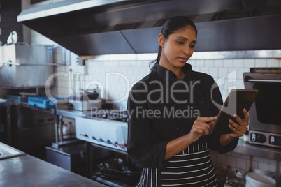 Waitress using tablet in cafe