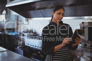Waitress using tablet in cafe