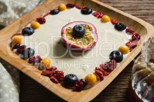 Fruit yogurt in plate on a wooden table