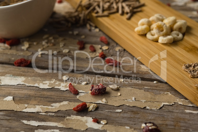 Breakfast cereals and dry fruits on wooden table