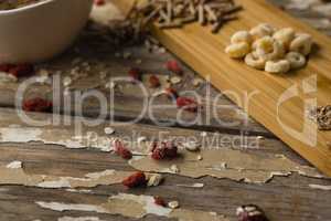 Breakfast cereals and dry fruits on wooden table