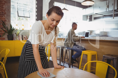 Waitress cleaning table