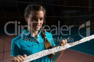 Portrait of volleyball player by net