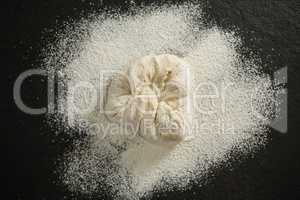Overhead view of flour on dough