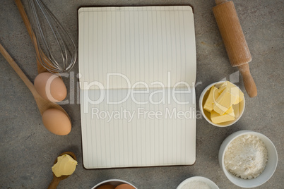 Overhead view of ingredients amidst open cookbook