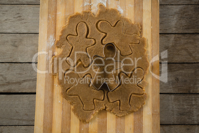 Overhead view of gingerbread man pastry cutter on dough