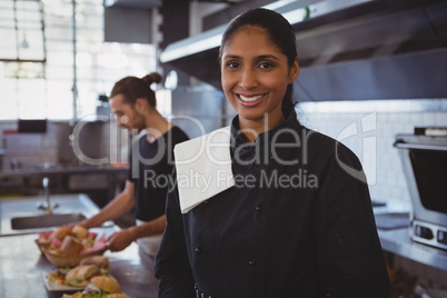 Portrait of waitress by coworker in cafe