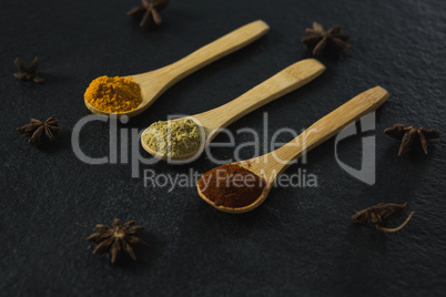 Star anise with various spices powder in wooden spoon