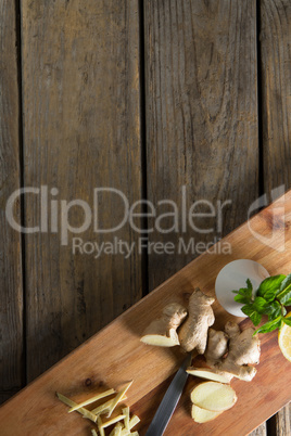 Overhead view of ginger on cutting board over table