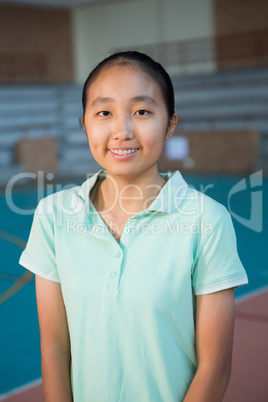 Smiling volleyball player standing in the court