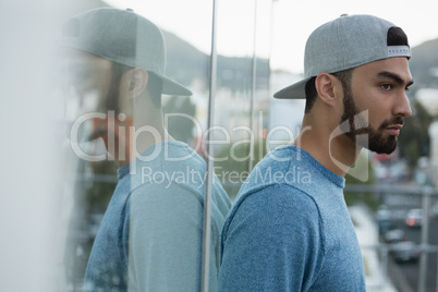 Handsome man leaning on glass