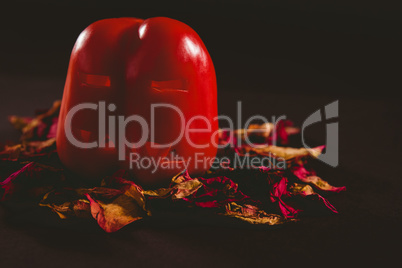 Carved red bell pepper with petals on wooden table