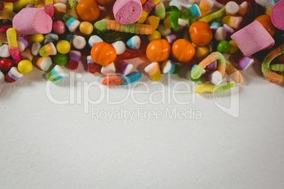 View of various candies over white background