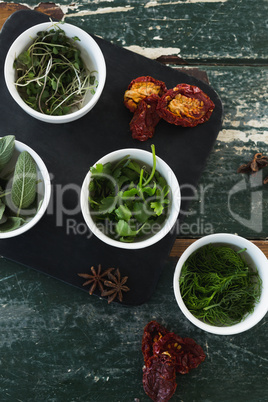 Various spices and herbs on wooden table