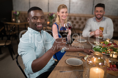 Happy friend dining together in restaurant