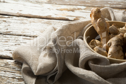 Close up of gingers in bowl on burlap over table