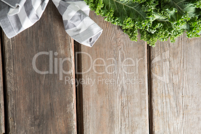 Cropped image of kale with napkin on table