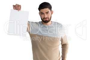 Portrait of man holding white blank sheet
