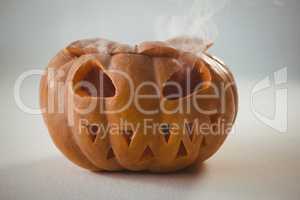 Orange jack o lantern on white background