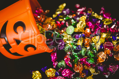 High angle view of bucket with colorful chocolates during Halloween