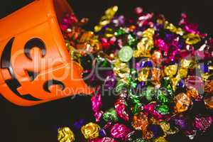 High angle view of bucket with colorful chocolates during Halloween