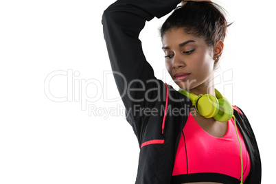 Female athlete with headphones looking away