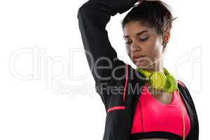 Female athlete with headphones looking away