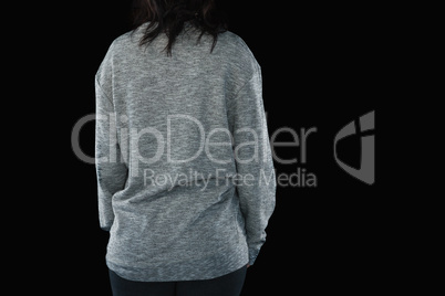 Rear view of young woman against black background