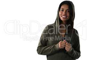 Smiling female athlete in hooded jacket
