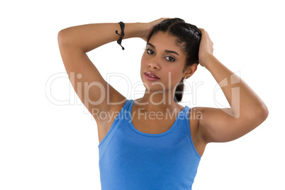 Portrait of young woman with hands in hair