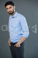 Handsome man posing against grey background