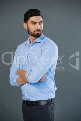 Handsome man posing against grey background