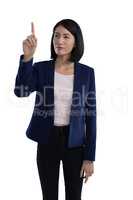 Businesswoman touching invisible screen