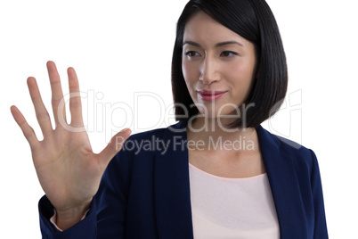 Businesswoman touching invisible screen
