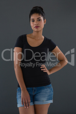 Portrait of confident woman with hand on hip