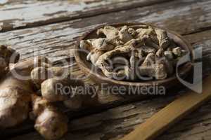 High angle view of dried gingers in plate on weathered table