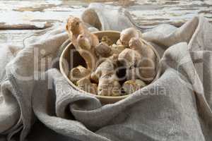 High angle view of gingers in bowl on burlap over table