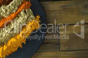 Various type of spice powder on slate plate