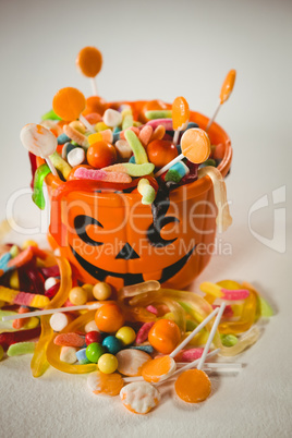 High angle view of bucket with various sweet food during Halloween