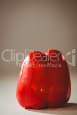 Carved red bell pepper over white background
