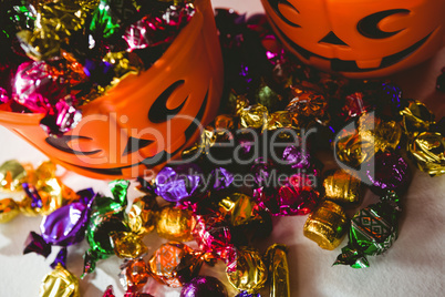 High angle view of orange buckets with colorful chocolates