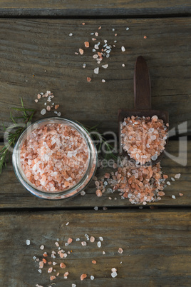 Himalayan salt and rosemary on wooden table