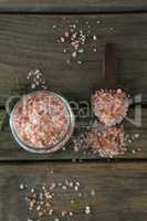 Himalayan salt and rosemary on wooden table