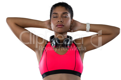 Female athlete with eyes closed against white background