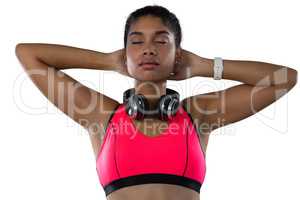 Female athlete with eyes closed against white background