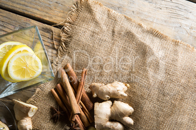 High angle view of ginger and cinnamons on burlap