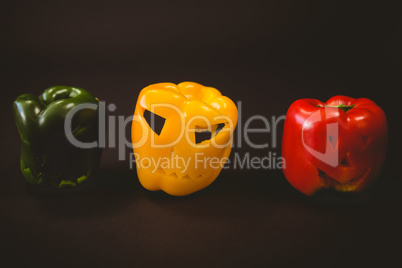 Carved bell peppers over black background