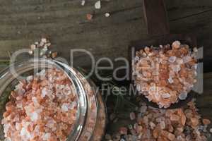 Himalayan salt and rosemary on wooden table