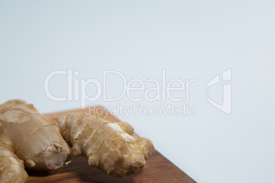 Close up of fresh ginger on wooden board