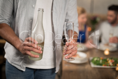 Mid section of man holding champagne